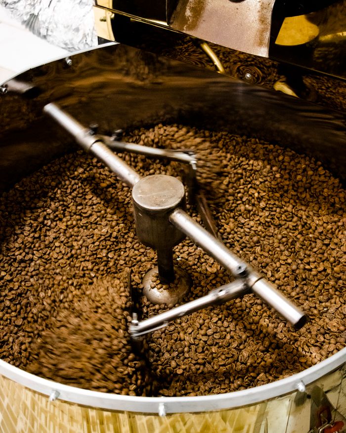 Close-up of freshly roasted coffee beans being ground in Tabriz, Iran.